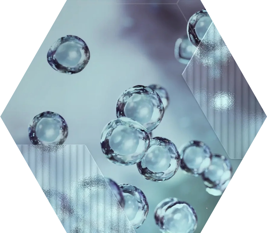 Hexagonal image showing transparent, spherical bubbles or cells floating against a soft blue and white background, with subtle geometric and lined overlay patterns.
