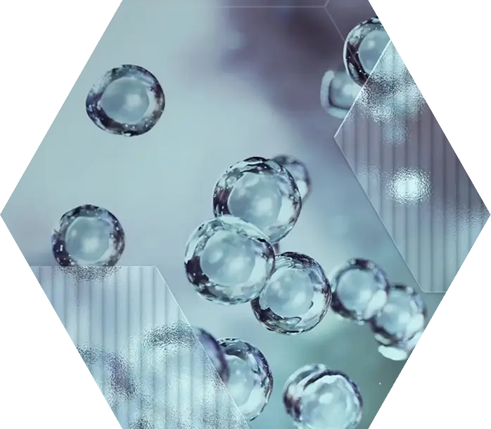 Translucent, spherical bubbles float against a soft blue background with geometric, semi-transparent hexagons overlaying parts of the image, giving it a scientific and futuristic appearance.