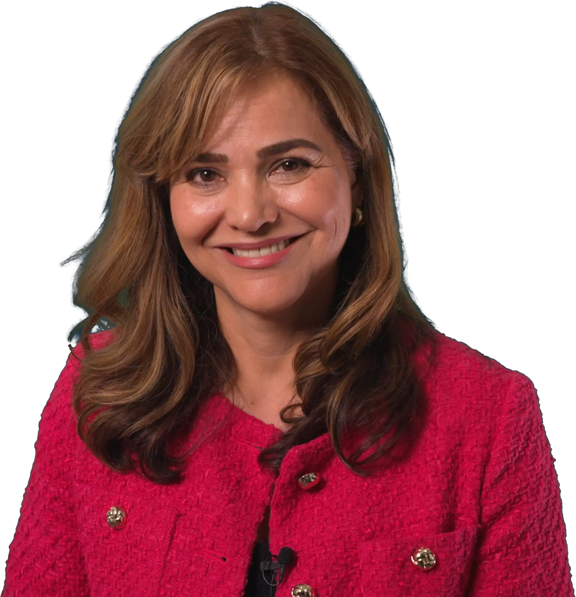 A woman with long brown hair smiles at the camera, wearing a bright pink textured blazer over a black top, set against a dark background.