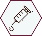Icon of a syringe with a droplet at the needle tip, outlined in dark lines inside a hexagonal border on a light background.